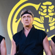 Johnny Lawrence (Billy Zabka, center) is flanked by his star pupils Hawk (Jacob Bertrand, left) and Miguel (Xolo Maridueña, right) in Cobra Kai season 2.